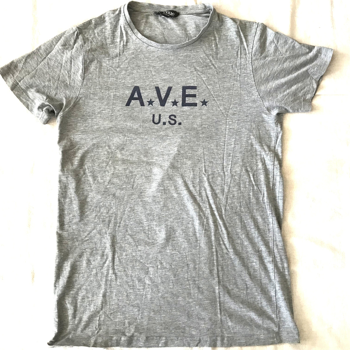 Brown and white striped polo shirt on a light gray surface