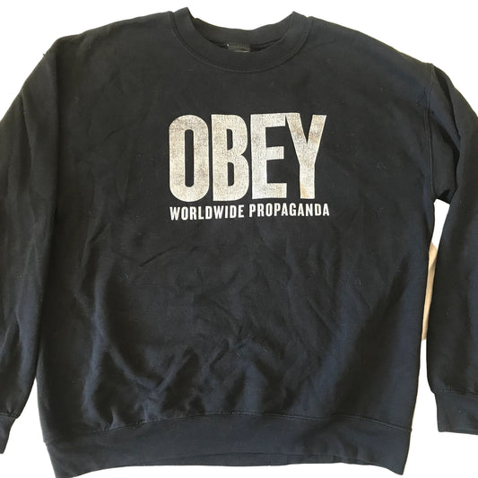 Black sweatshirt with 'OBEY Worldwide Propaganda' text on a white background