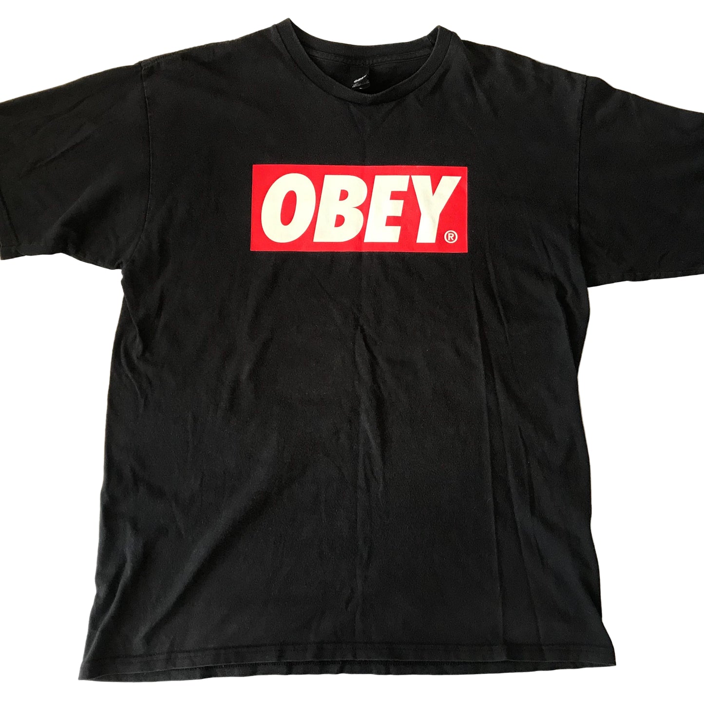 Black t-shirt with 'OBEY' logo on a light-colored surface