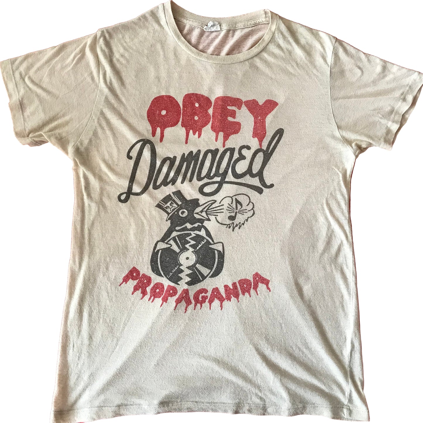 White t-shirt with 'Obey Damaged Propaganda' graphic on a red background